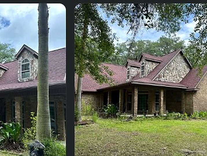 Large brick home with a deep red architectural shingle roof